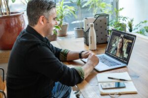 Someone sitting at a table on a video call